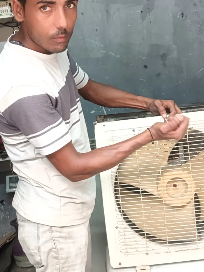 Vayu AC Service technician servicing an outdoor AC unit in Greater Noida