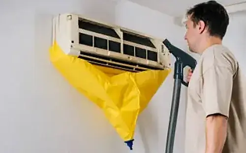 Vayu AC Service technician cleaning a split AC indoor unit in Greater Noida
